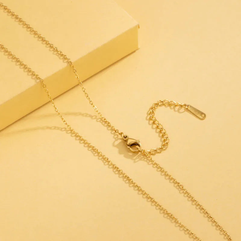 Gold necklace on a yellow background
