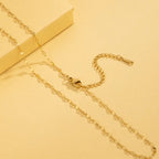 Gold chain necklace on a yellow background