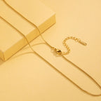 Gold necklace on a yellow background