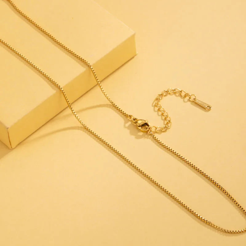 Gold necklace on a yellow background
