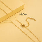 Gold necklace on a yellow background with measurement text