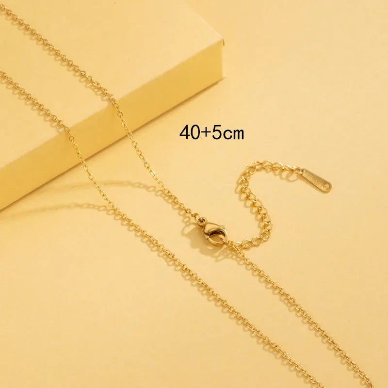 Gold necklace on a yellow background with measurement text