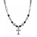 Necklace with black beads and silver cross pendants on a white background