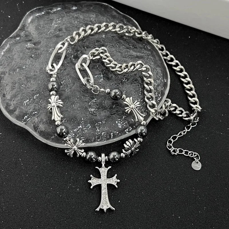 Silver bracelet with cross charms on a dark surface