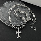 Silver bracelet with cross charms on a dark surface