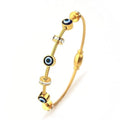 Gold bracelet with blue evil eye beads on a white background