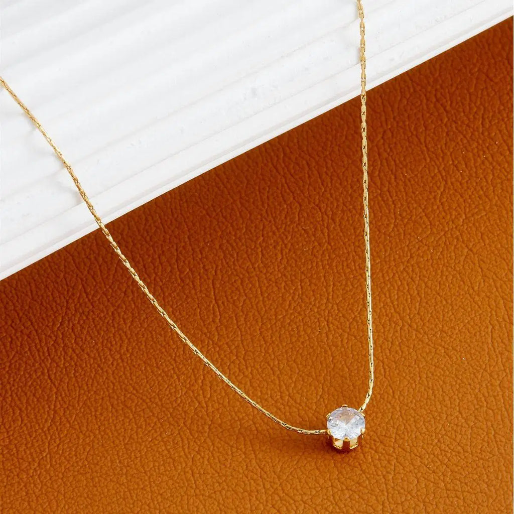 Delicate gold chain featuring the Old-Tone Solitaire Pendant Necklace with a single sparkling clear stone, perfect for elegant daily wear and minimalist fashion jewelry looks.