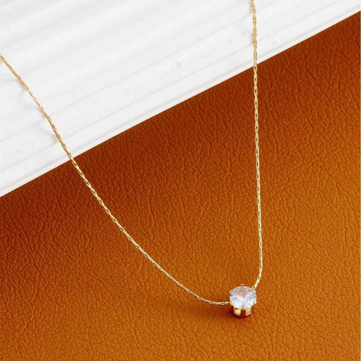 Delicate gold chain featuring the Old-Tone Solitaire Pendant Necklace with a single sparkling clear stone, perfect for elegant daily wear and minimalist fashion jewelry looks.