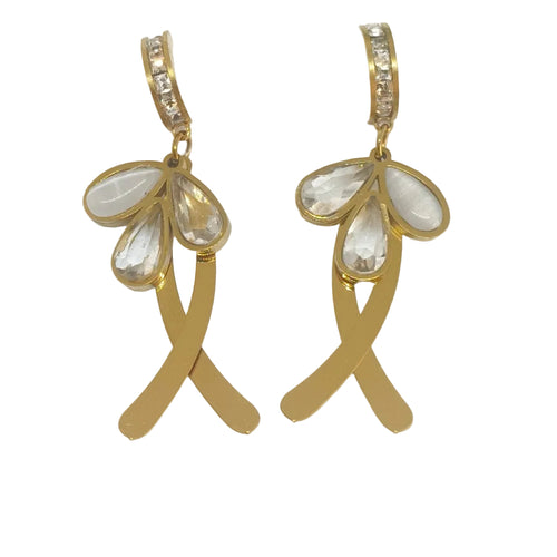 A pair of gold drop earrings with clear teardrop-shaped rhinestones and a curved gold bar with small clear stones at the top, displayed on a white card against a white background.