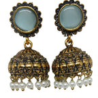 A pair of traditional Indian jhumka earrings with round light blue stone studs, gold-plated filigree bells, and dangling white faux pearls, shown on a plain white background.