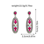 Pair of earrings with pink gemstones and measurements on a white background