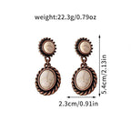 Pair of earrings with measurements and weight displayed on a white background