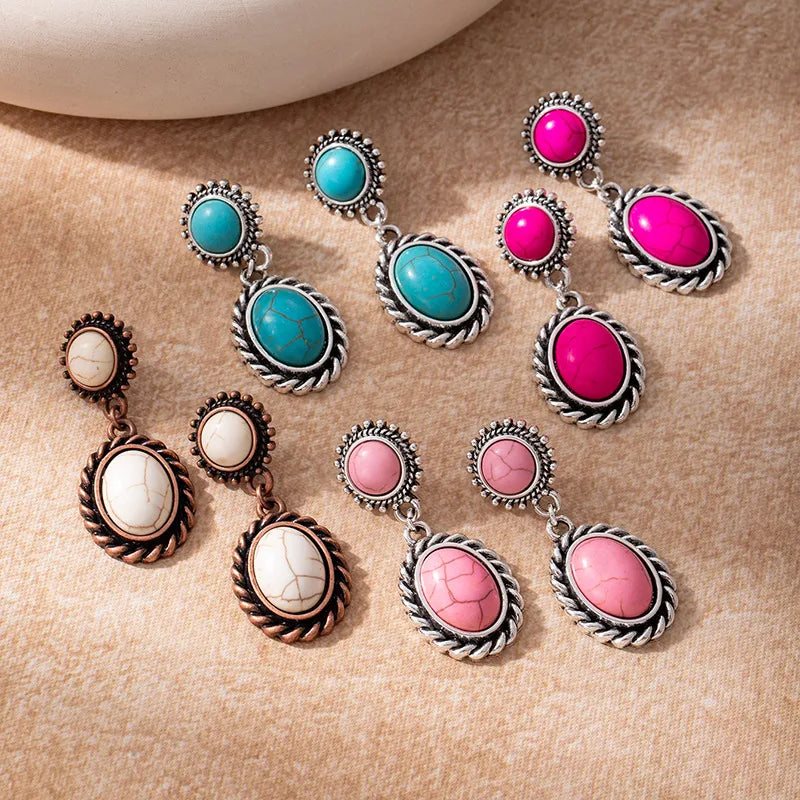 Set of colorful earrings on a beige background