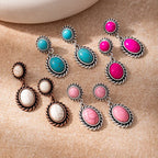 Set of colorful earrings on a beige background