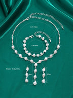 Pearl jewelry set with necklace, bracelet, and earrings on a green satin background with measurements.