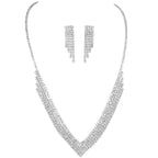 Silver necklace and earrings set on a white background
