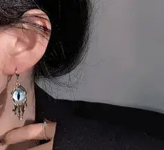 Close-up of an earring with a dark background