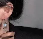 Close-up of an earring with a dark background