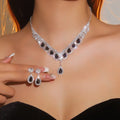 Necklace and earrings set on a mannequin with a blurred background