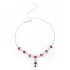 Necklace with red gemstones on a white background