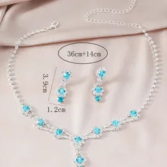 Jewelry set with necklace, earrings, and measurements on a light pink background