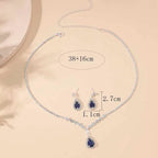 Jewelry set with necklace and earrings on a beige background, showing measurements.