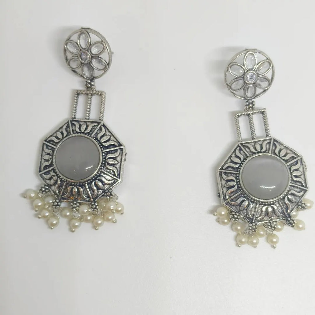 A pair of silver-toned dangle earrings with oval gray stone centers and clusters of small white pearls at the bottom, displayed on a plain white background.