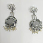 A pair of silver-toned dangle earrings with oval gray stone centers and clusters of small white pearls at the bottom, displayed on a plain white background.