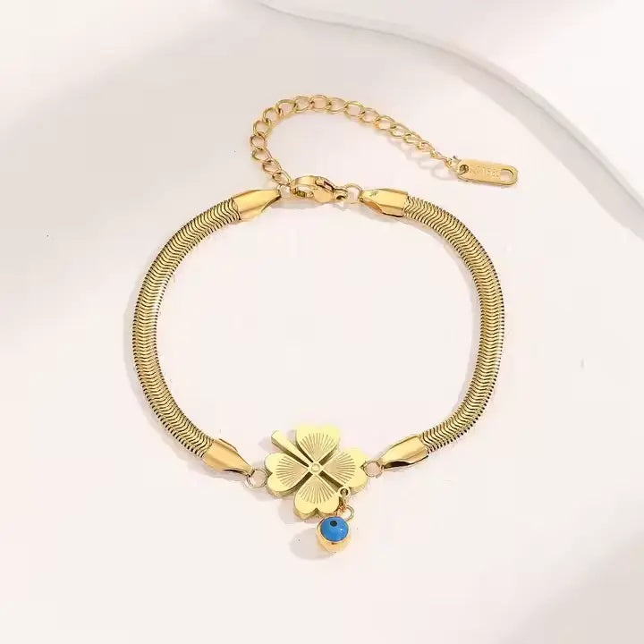 Evil's Eye Leaf Charm Snake Chain Bracelet featuring a polished gold plated snake chain with a four-leaf clover charm and a small blue evil eye charm, elegant fashion jewelry.