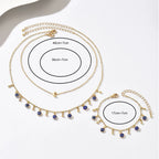Gold necklace with blue eye charms and measurements on a white background