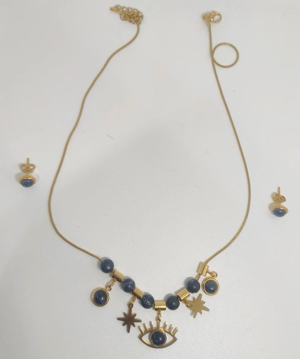 Gold necklace with blue beads and charms on a white background