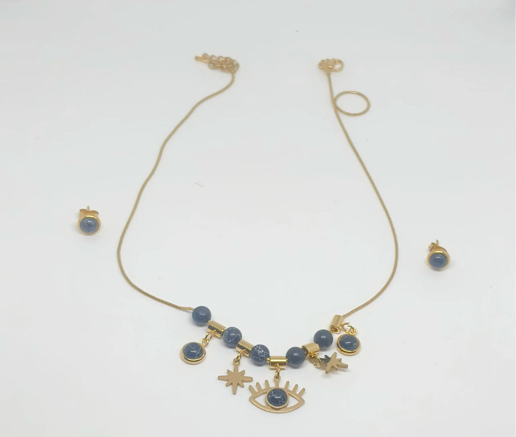 Gold necklace with blue beads and eye-shaped charms on a white background