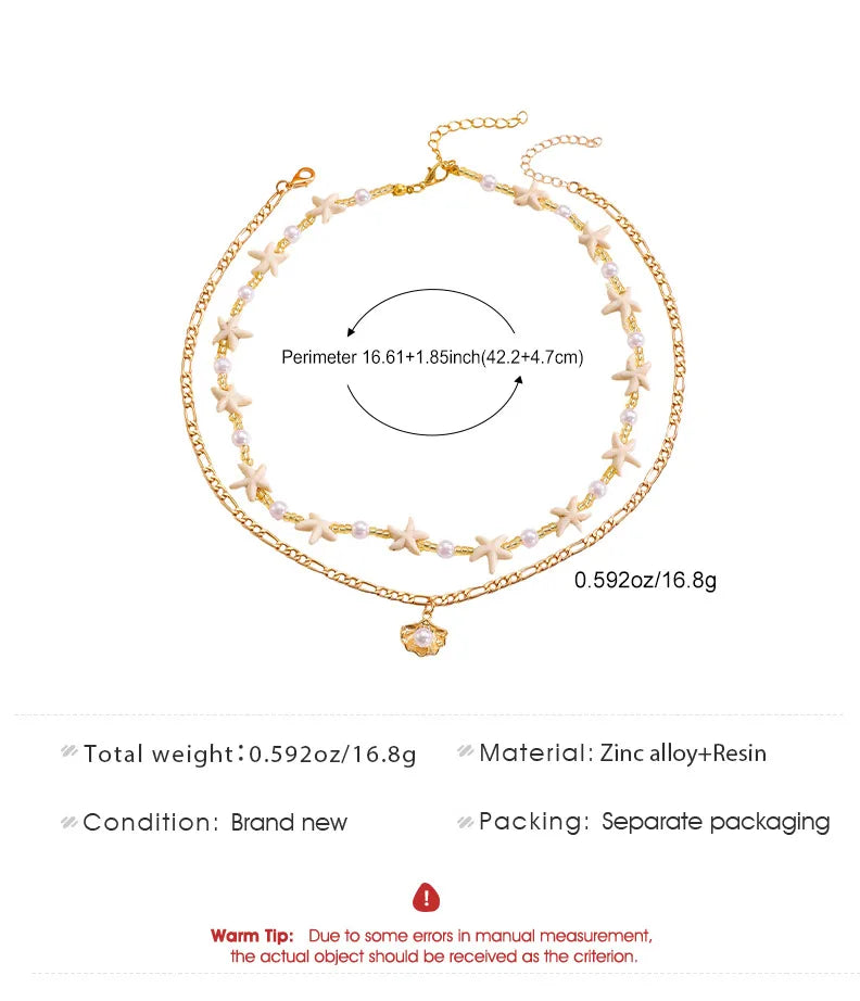 Gold necklace with star and heart charm on a white background