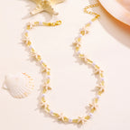 Necklace with starfish and pearl details on a beige background