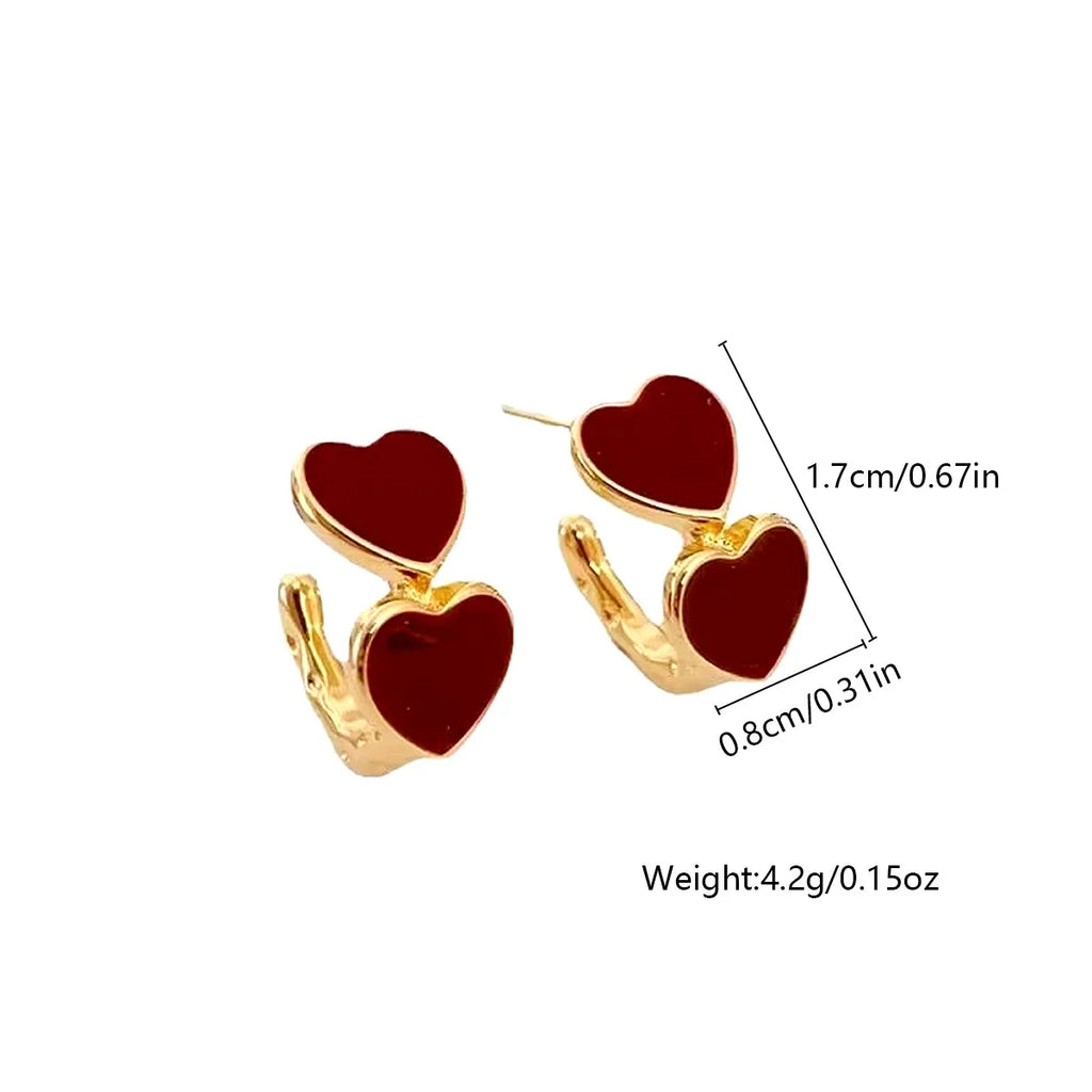 Heart-shaped earrings with gold accents and red hearts, shown with measurements and weight on a white background.