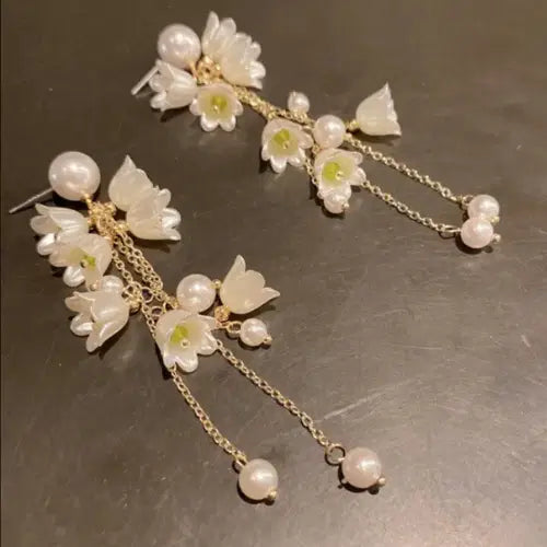 Delicate Long Flower Tassel Jewelry Earring featuring translucent white floral motifs with pearl accents and fine gold-toned chains, perfect for elegant and stylish occasions.