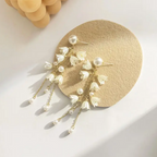 Long Flower Tassel Jewelry Earring featuring delicate white flower charms and pearl accents suspended from gold chains, perfect for elegant and trendy fashion jewelry looks.