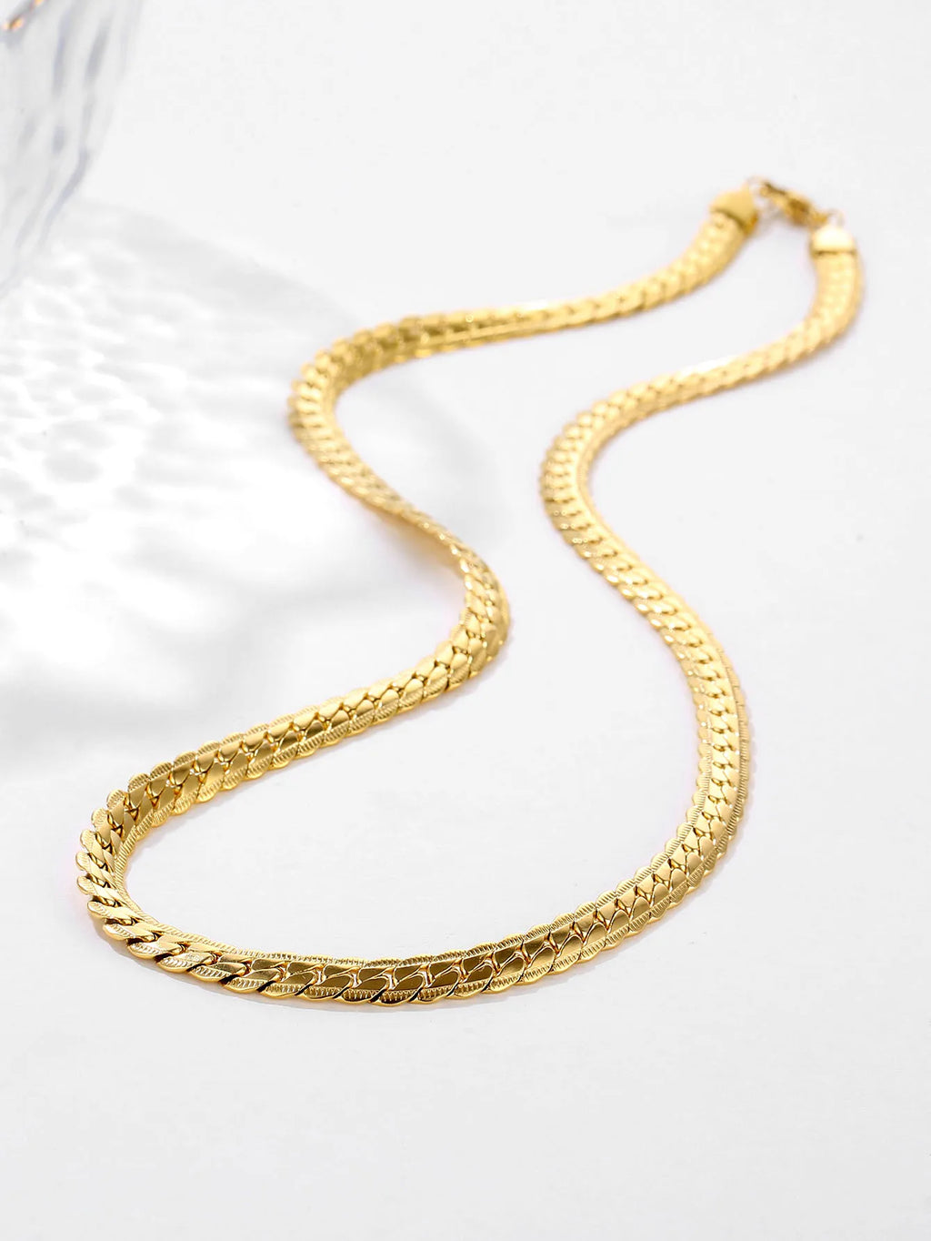 Gold chain necklace on a white background