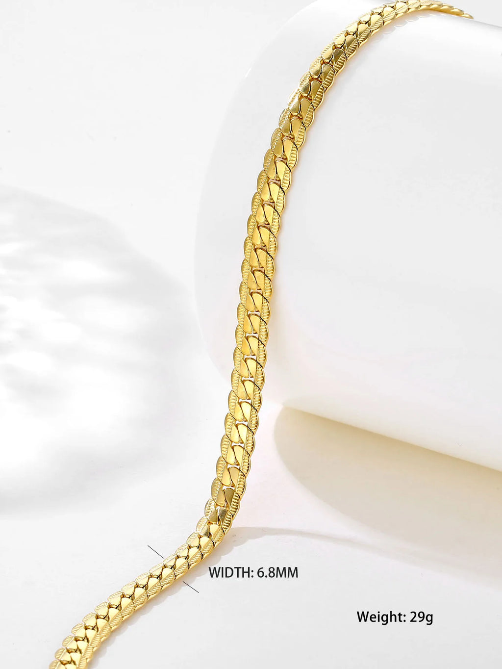 Gold bracelet on a white background with measurements displayed.