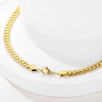 Gold chain bracelet on a white background