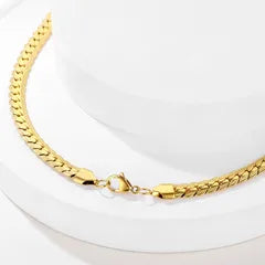 Gold chain bracelet on a white background