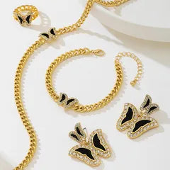 Gold jewelry set with necklace, bracelet, and earrings on a white background