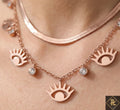 Necklace with eye-shaped pendants on a person's neck