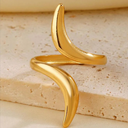 Serpentine Line Ripple Ring featuring a sleek, curved design in polished gold tone, perfect for adding a modern and elegant touch to your fashion jewelry collection.
