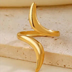 Serpentine Line Ripple Ring featuring a sleek, curved design in polished gold tone, perfect for adding a modern and elegant touch to your fashion jewelry collection.