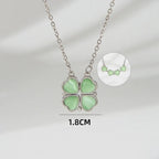 Necklace with four green heart-shaped pendants on a gray background