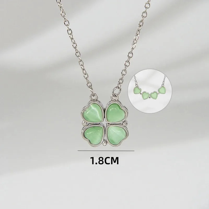 Necklace with four green heart-shaped pendants on a gray background