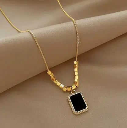 Square Beads Black Pendant Chain Necklace featuring gold square beads with a black rectangular pendant surrounded by a delicate gold frame, elegant fashion jewelry for women.