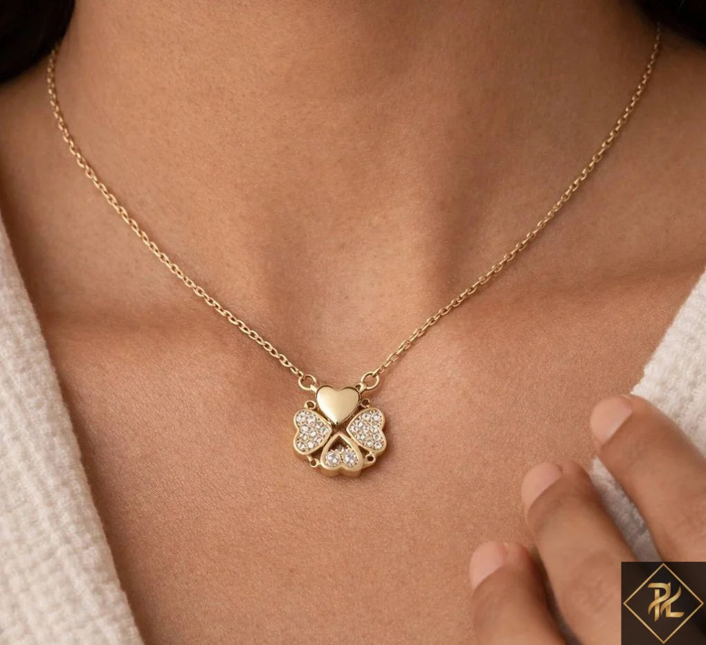Gold necklace with a clover-shaped pendant on a person's neck