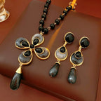 Jewelry set with necklace and earrings on a brown surface